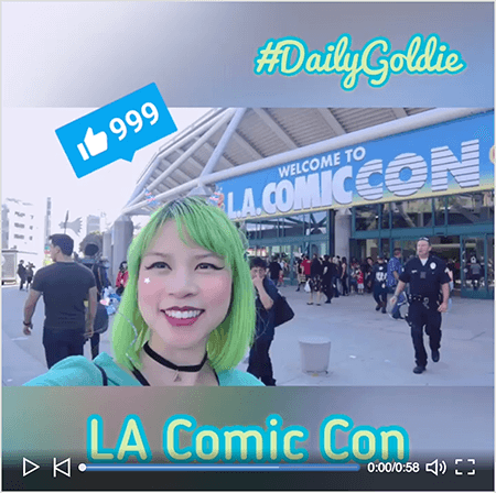 Detta är en skärmdump av en Goldie Chan LinkedIn-video med en startskärm. Videon sköts horisontellt på en smartphone och förvandlas till en fyrkantig video med suddig brevlåda ovanför och under videon. Startvideobilden visar Goldie framför kongresscentret för LA Comic Con. Goldie dyker upp från axlarna uppåt. Hon är en asiatisk kvinna med grönt hår. Hon har smink, ett svart chokerhalsband och en turkos skjorta. I brevlådområdet ovanför videon visas #DailyGoldie i ett ljusgrönt manus-teckensnitt med en turkos kontur. En LinkedIn Like-ikon med siffran 999 visas i en blå ruta över Goldies huvud. I brevlådområdet under videon visas texten “LA Comic Con” i ett ljusgrönt san serif-teckensnitt med en turkos kontur.